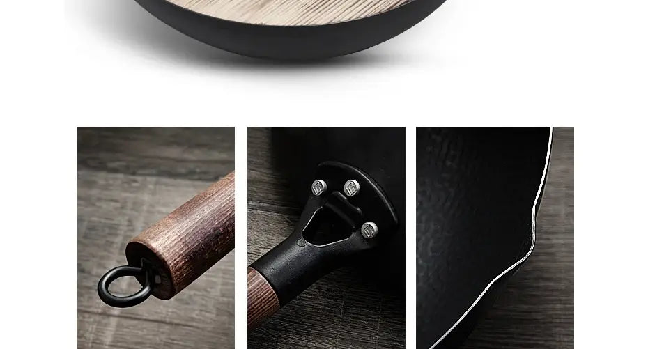 Wok artesanal de hierro fundido negro con asa de madera y remaches metálicos, mostrado desde el lado posterior