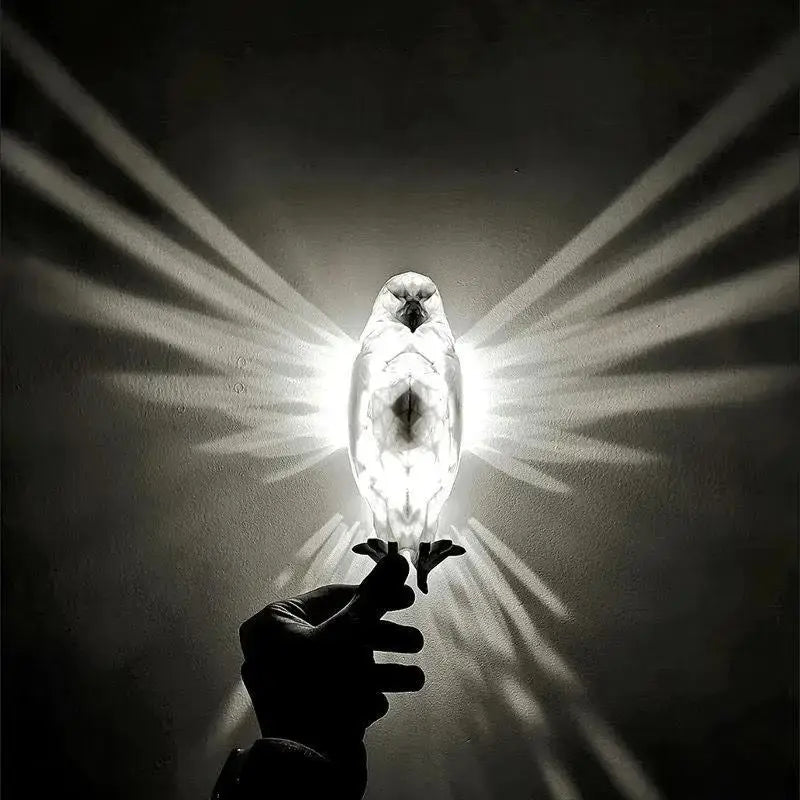 A sleek symmetrical owl-shaped 3d printed geometric animal wall lamp with a translucent white body and dark central details.