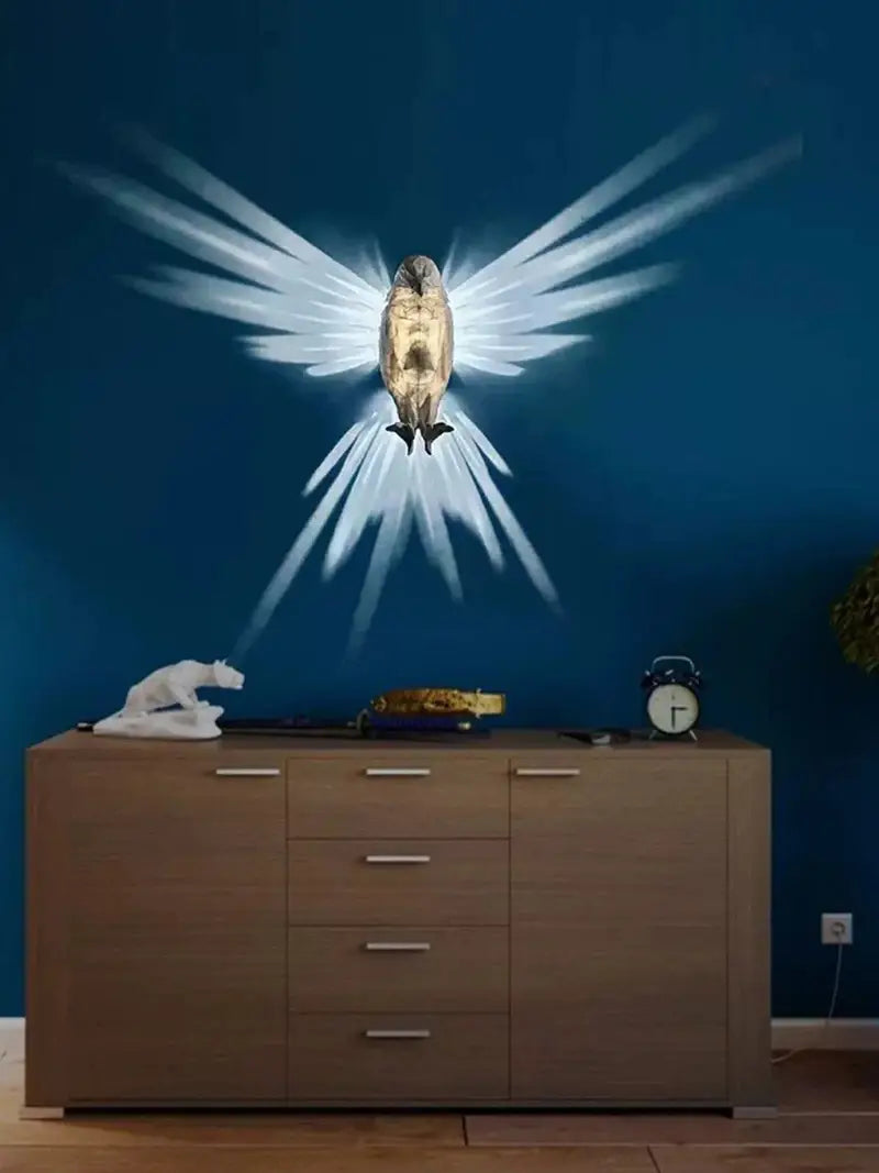 Golden owl-shaped animal wall lamp 3d printed geometric sconce light with radiant white wing-like light beams and metallic gold finish.