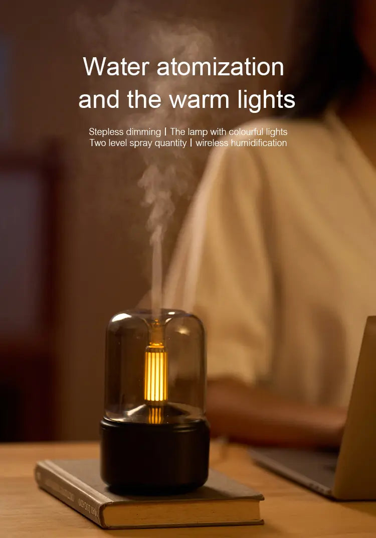 A sleek black Candlelight Aroma Diffuser USB mist humidifier with a glass dome and warm golden light emitting mist for ambiance.