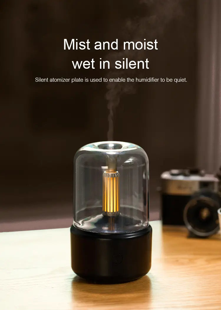 A sleek black and transparent glass candlelight aroma diffuser usb mist humidifier with a golden atomizer plate emitting gentle mist.