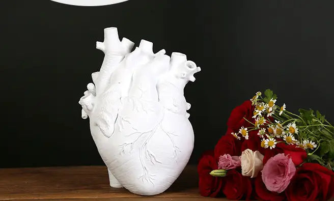 White anatomically detailed heart-shaped vase made of Nordic resin sculpture, suitable as a flower pot.