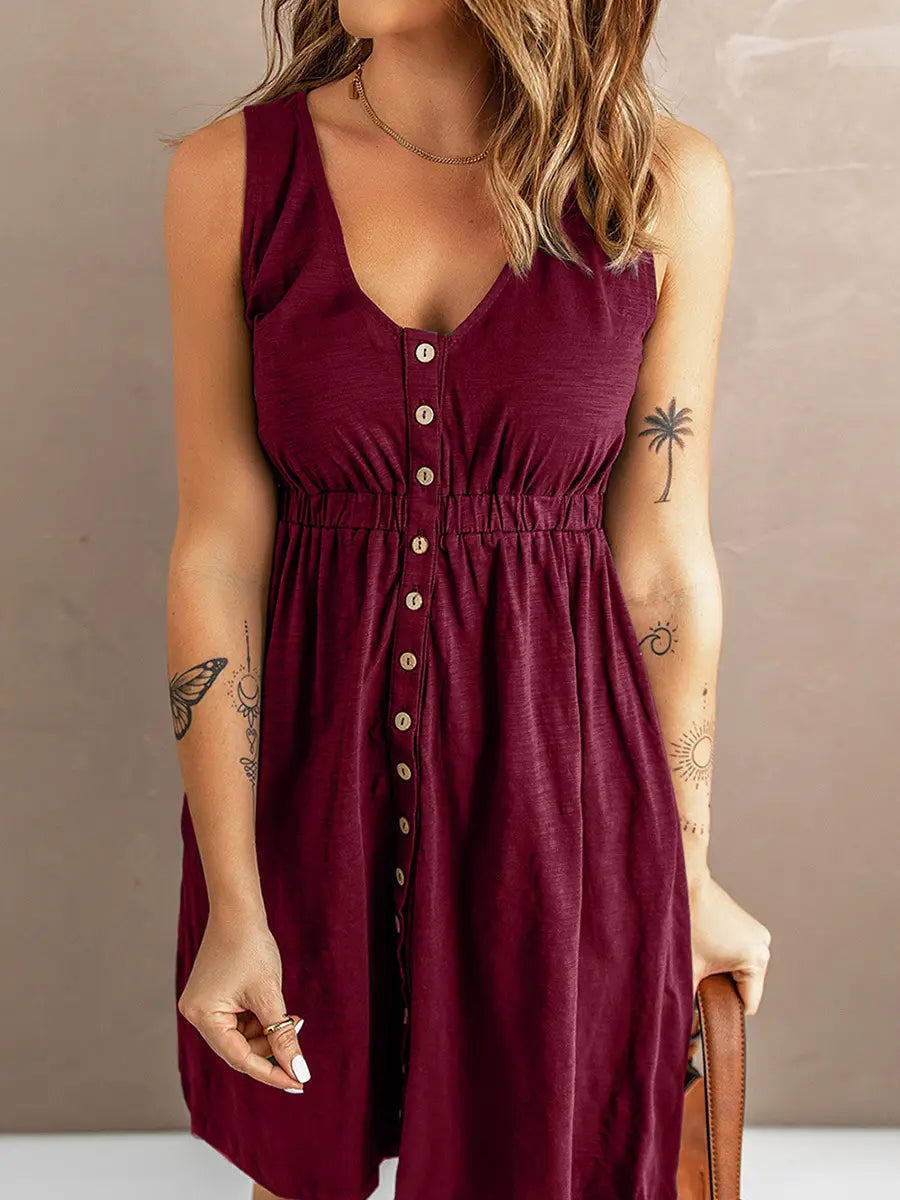 A sleeveless maroon a line dress with v neckline and front button closure.