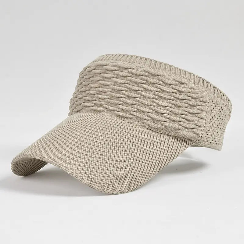 Beige knitted visor cap with a textured woven pattern and breathable mesh side panels designed for summer sports.