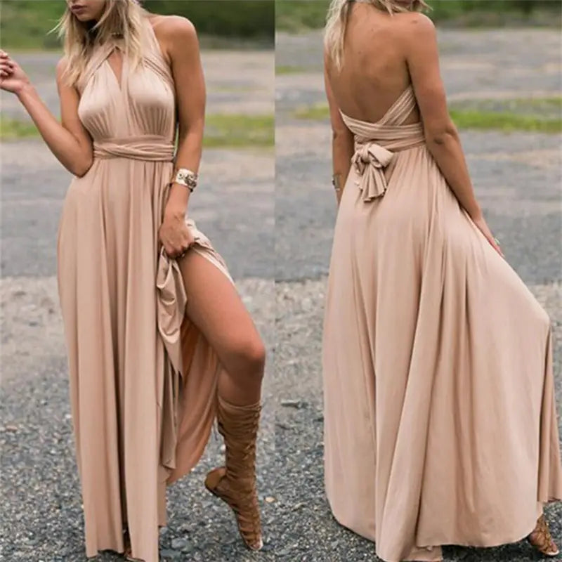 Beige women’s boho multiway halter neck flowing maxi dress with a draped back and side slit shown from the back.