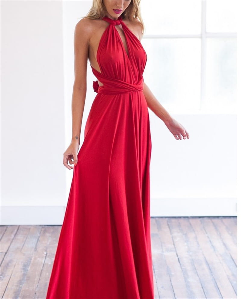 A flowing red boho maxi dress with a halter neck and draped waist and back detail shown from the back side.