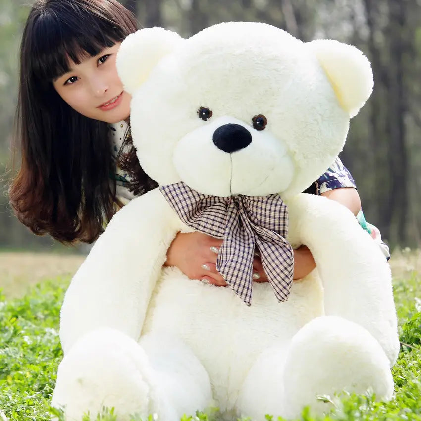 A plush white teddy bear stuffed animal for kids with black button eyes, black nose, and a plaid bow tie available in sizes 40 to 200 centimeters.