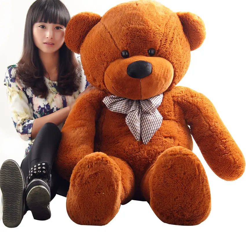A plush medium-brown teddy bear stuffed animal for kids featuring a black nose button eyes and a checkered bow tie available in sizes 40 to 200 cm.