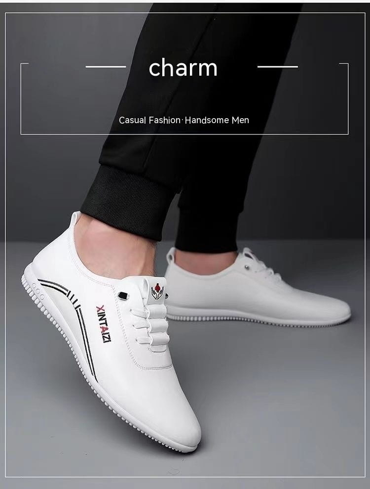 Zapatillas planas casuales de cuero blanco ligeras y transpirables con logotipado negro y un logotipo floral sutil en la lengüeta