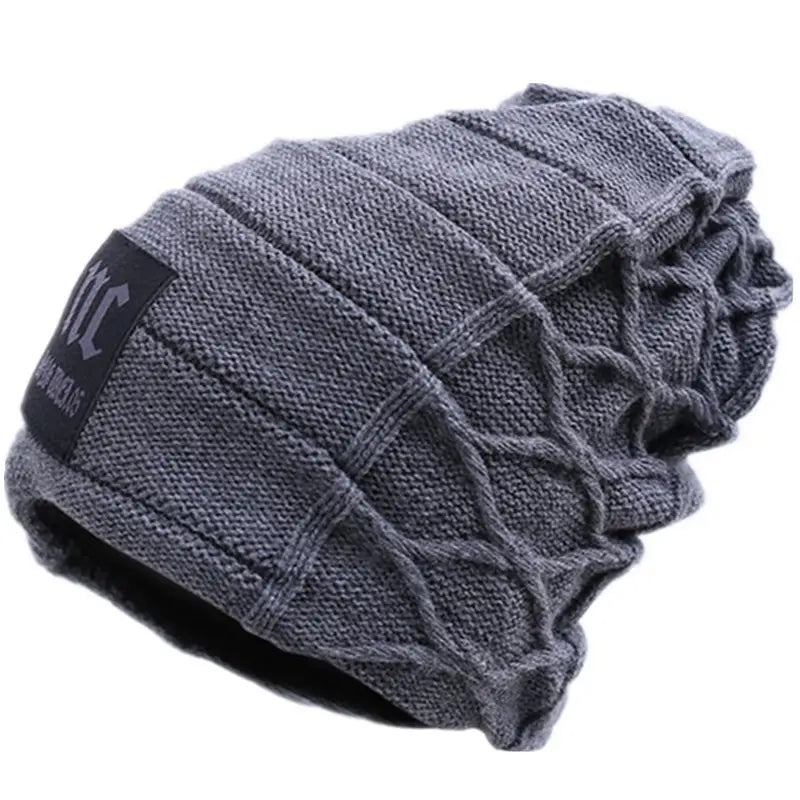 Men’s fleece lined knitted winter beanie hat in gray with a textured cable knit pattern and a black fabric patch on the side.