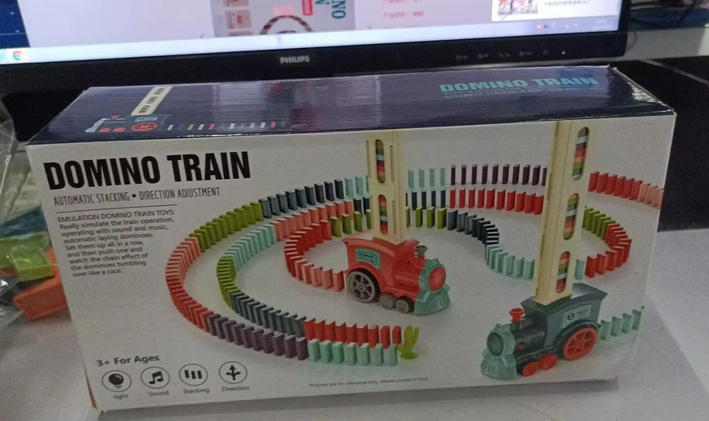 Red and teal plastic train engine with wooden track pieces in a colorful domino style layout from the domino train toy automatic electric building blocks set.