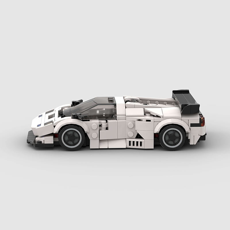 Lego Technic sports car model Diablo GT in white and black with transparent cockpit and detailed aerodynamic features made of building blocks.