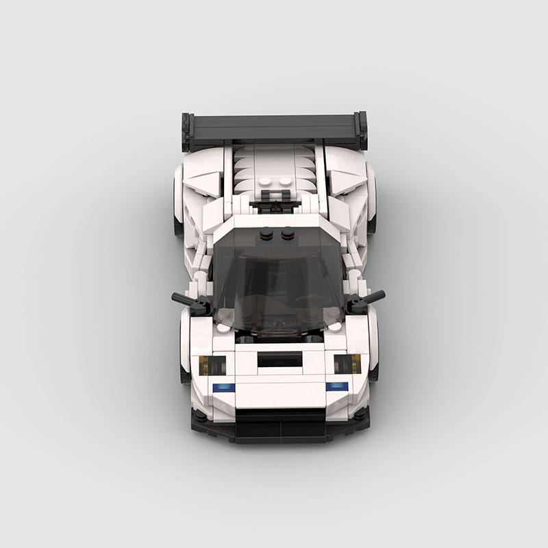 lego technic sports car model diablo gt building blocks featuring a white and black lego race car with a sleek aerodynamic design and a prominent rear spoiler viewed from the back side.