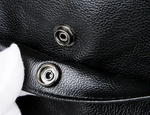 Men’s pu leather travel duffel bag in black textured leather with two silver toned metal snap buttons.