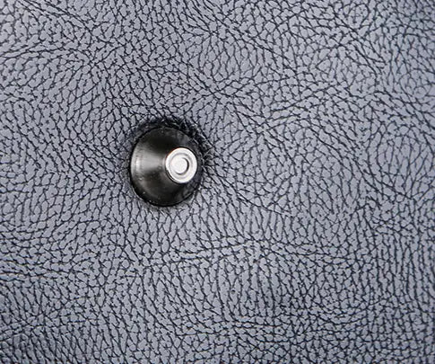 Men’s pu leather travel duffel bag 20 to 35 liter capacity featuring black textured leather with a circular metallic button in the center.