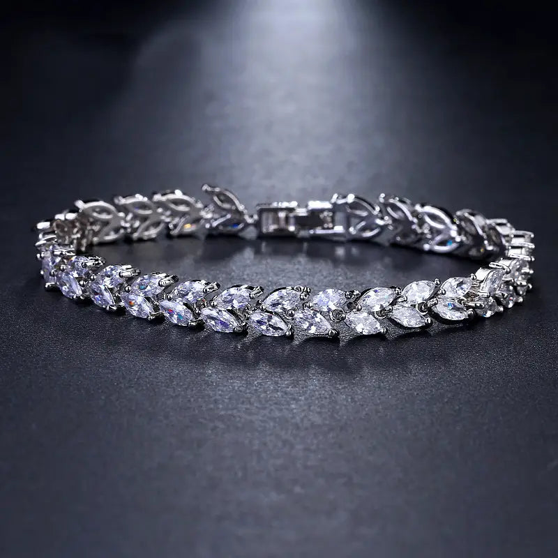 A sparkling silver marquise zircon leaf tennis bracelet featuring a row of marquise-cut clear crystals set in an intricate leaf-like metal design.
