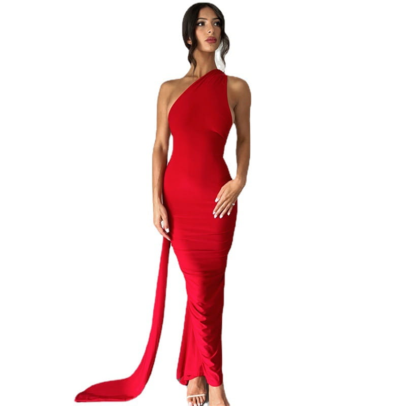 A striking red one shoulder mermaid backless train dress with a flowing train and sleek form-fitting silhouette.
