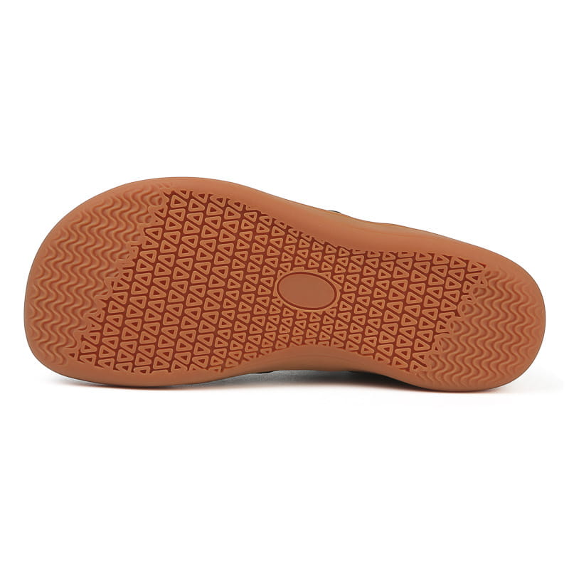 Tan rubber sole with a pattern of interlocking triangles and wavy lines for grip on fly-knit wide last sneakers breathable mesh shoes.