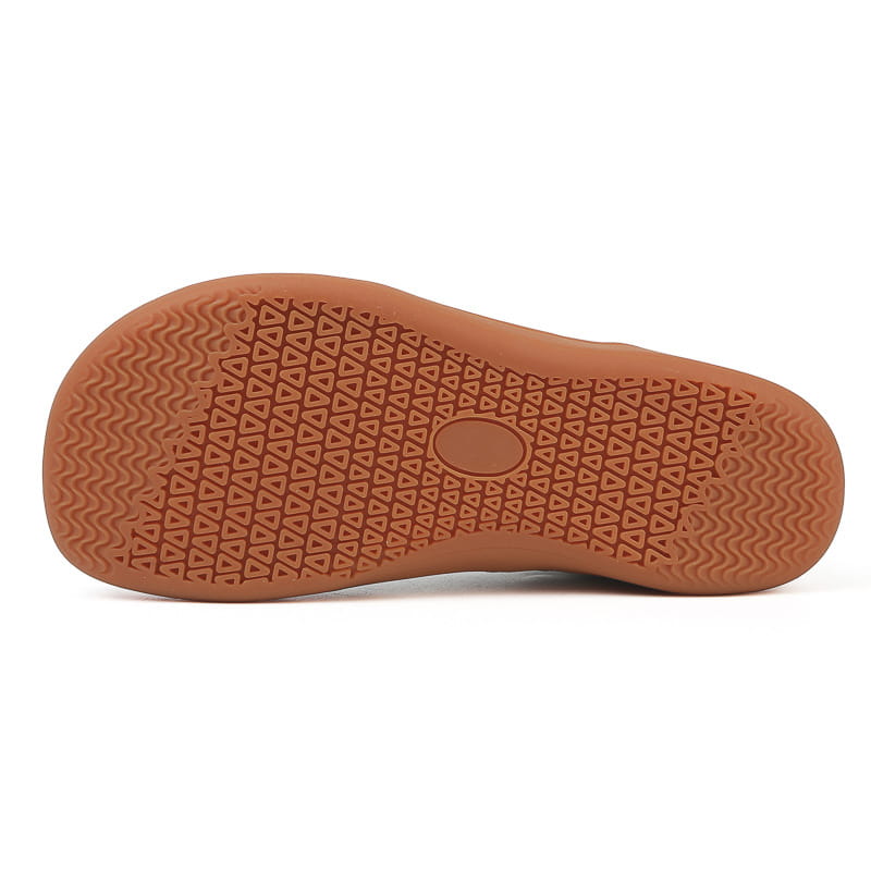 Tan rubber sole with an interlocking triangle and wavy line pattern for grip on fly-knit wide last sneakers breathable mesh shoes.