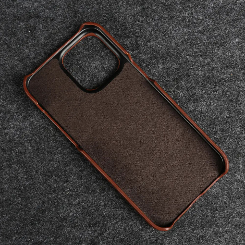 Brown leather iPhone case with a textured surface and matching brown frame shown from the back side designed for vintage horse oil drop resistance.
