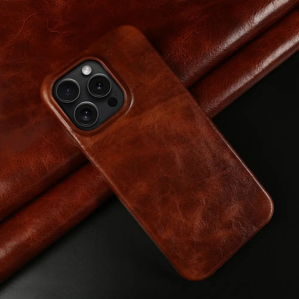 Brown leather iPhone case with a textured, slightly worn finish shown from the back side featuring vintage horse oil drop resistant material.