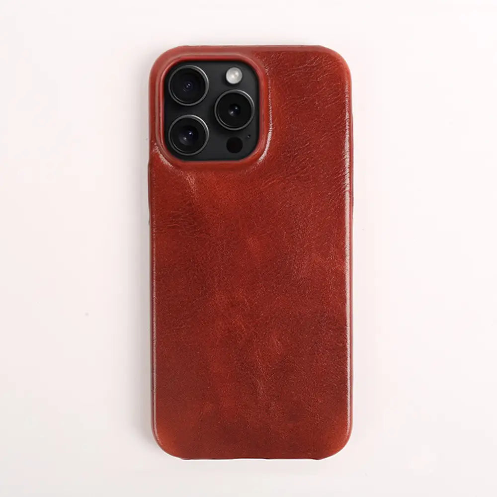 A rich brown leather iphone 13 pro max case with a textured surface designed for vintage horse oil drop resistance shown from the back side.