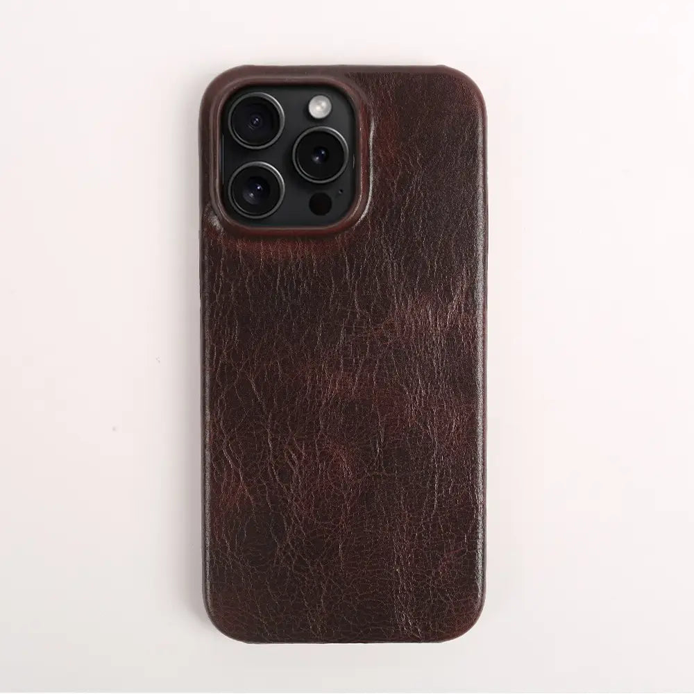 Dark brown leather iPhone case vintage horse oil drop resistant showing the back side with a textured slightly cracked surface and precise cutout for the camera module.