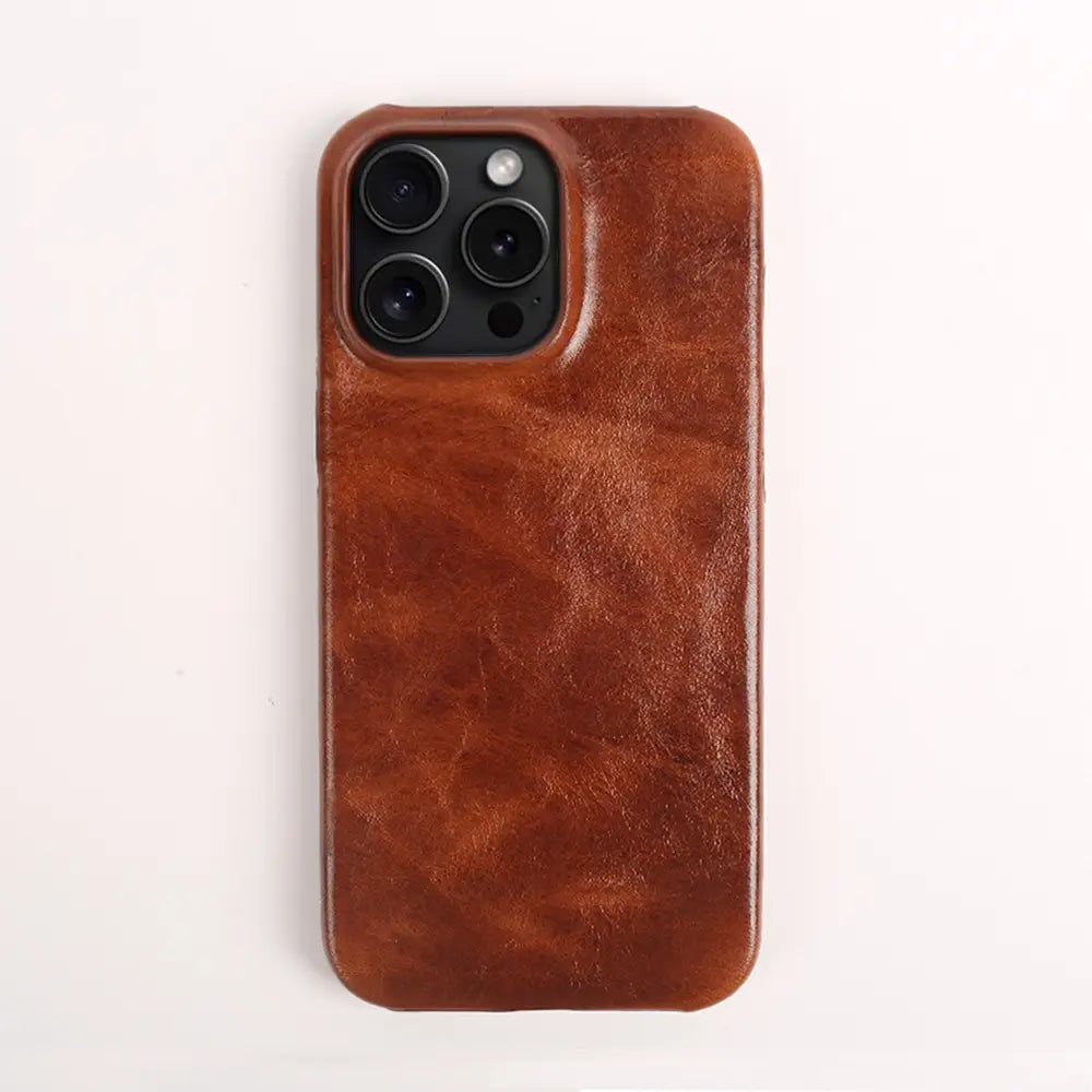 Brown leather iPhone case with a textured slightly worn finish shown from the back featuring vintage horse oil drop resistant material.