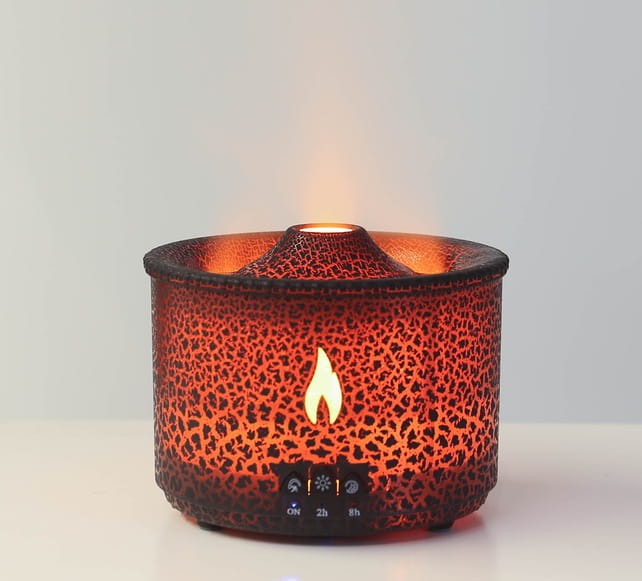 A warm amber-colored volcano flame diffuser jellyfish air humidifier with a textured crackled surface and an illuminated flame-shaped led light on the front panel.