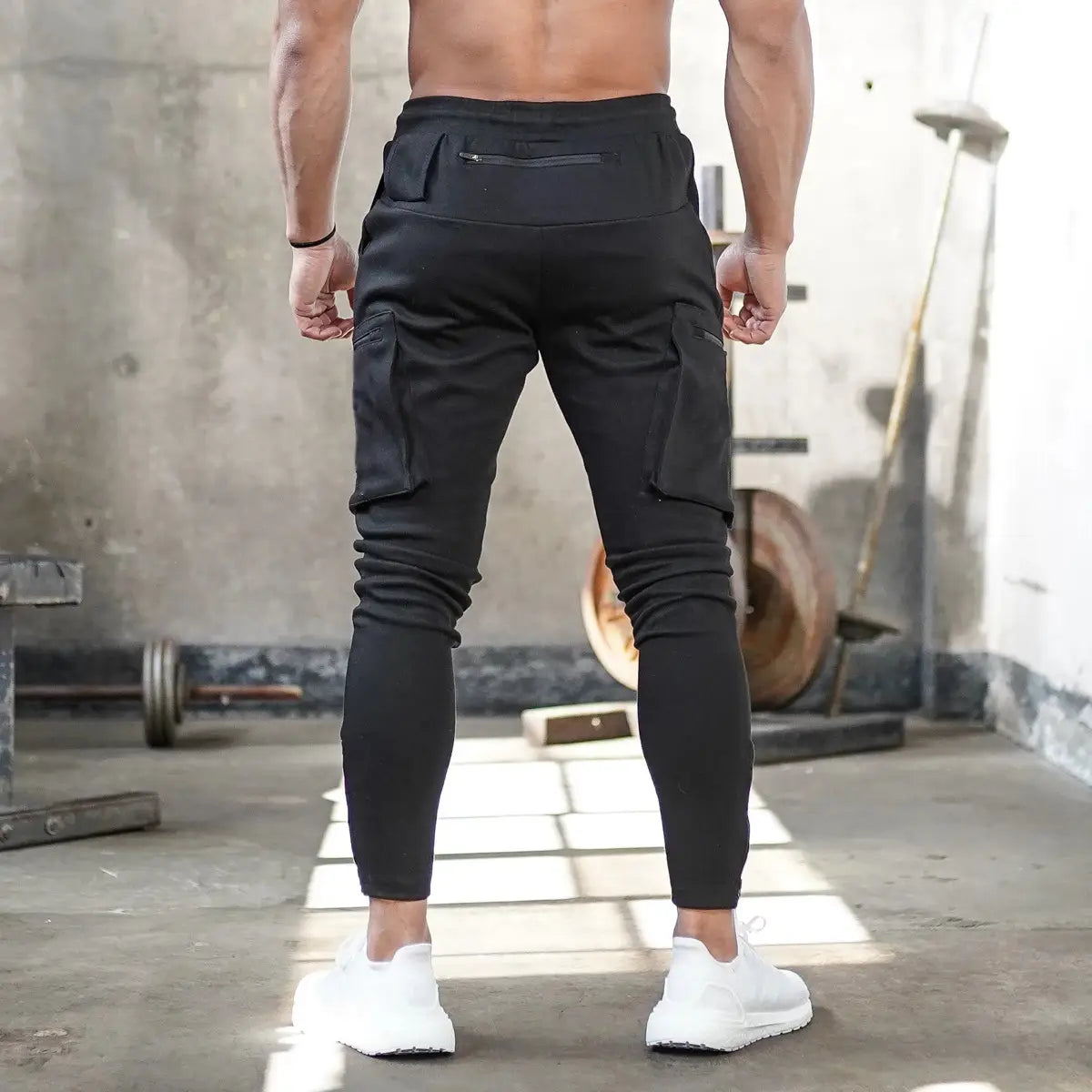 Men camouflage cargo joggers sports pants in black with multiple pockets and slim fit designed for athletic wear.