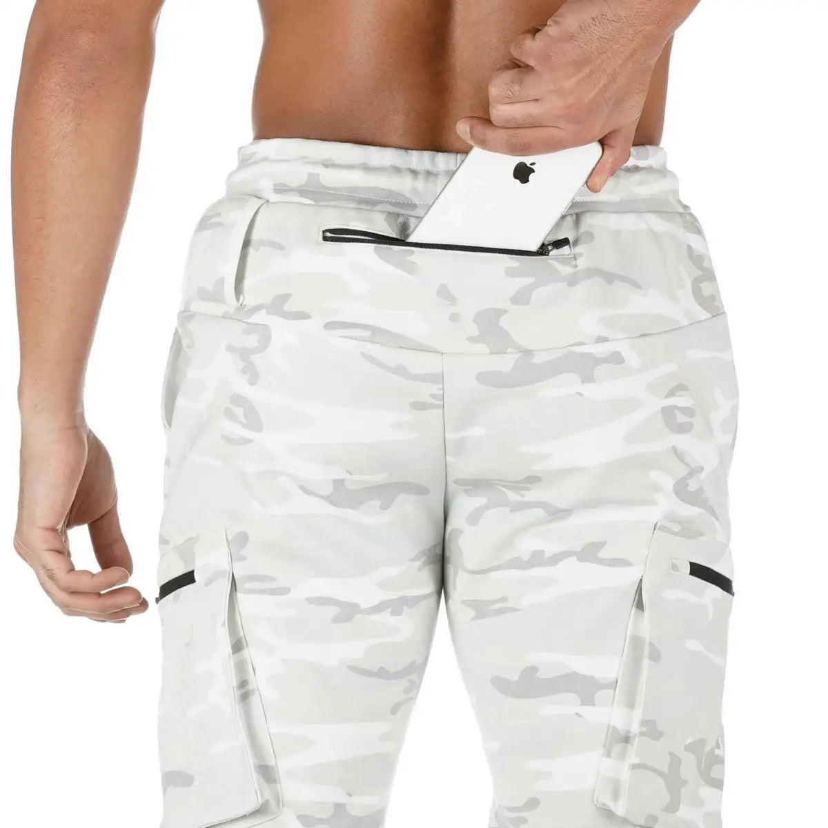 Men camouflage cargo joggers sports pants in white and gray camouflage with black zipper accents designed for casual and athletic use.