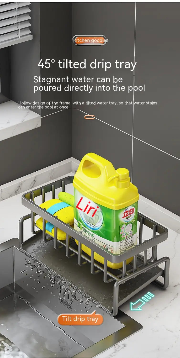 Silver metal kitchen sink storage rack stainless steel organizer with a 45-degree tilted hollow frame drip tray positioned under a sink to catch and drain water.