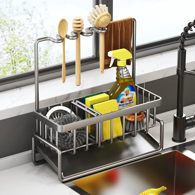 Stainless steel kitchen sink storage rack organizer with multiple compartments and hooks for utensils sponges and cleaning supplies.