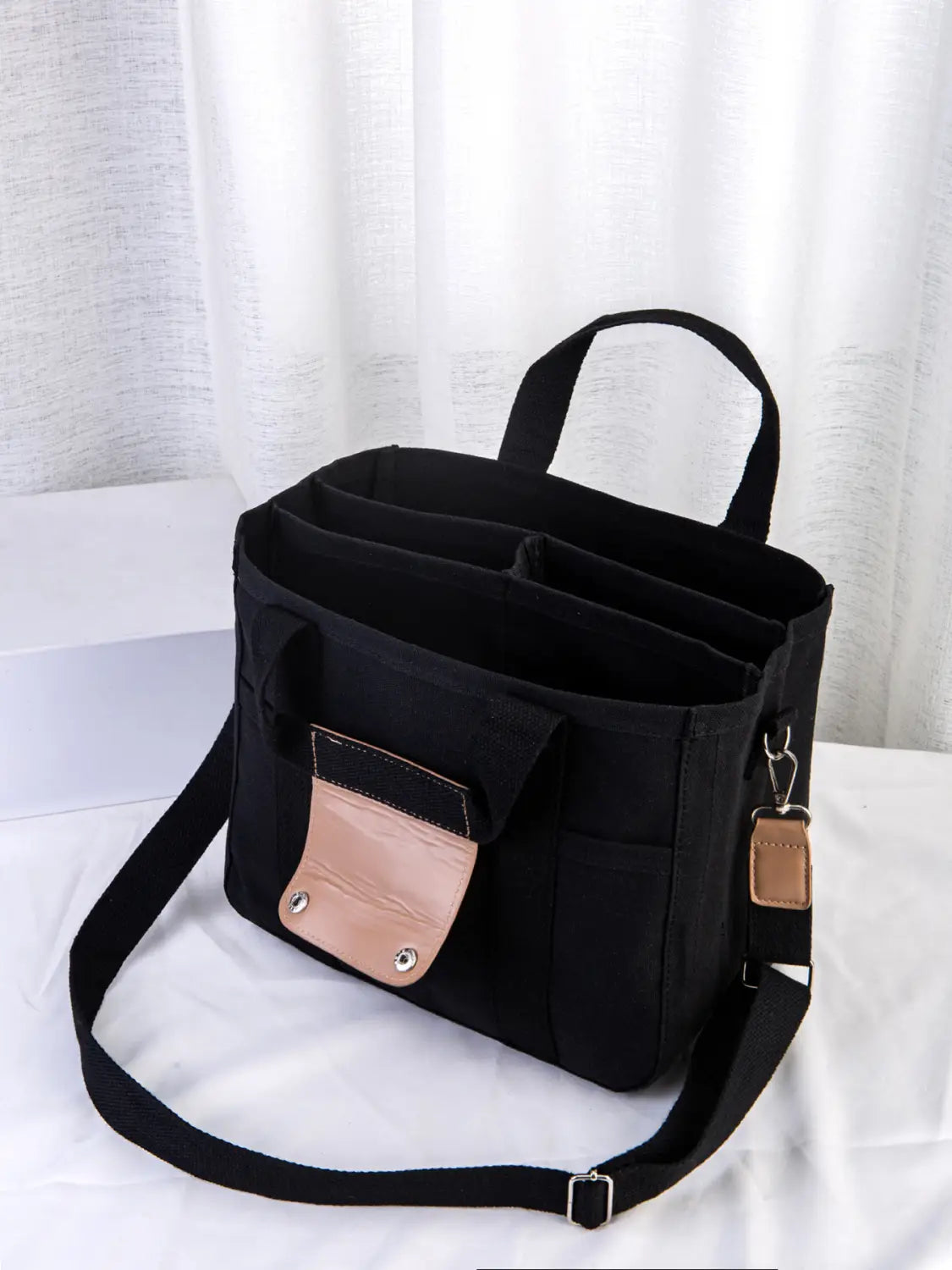 black fabric canvas messenger bag mother and baby travel tote with tan leather accents and detachable shoulder strap