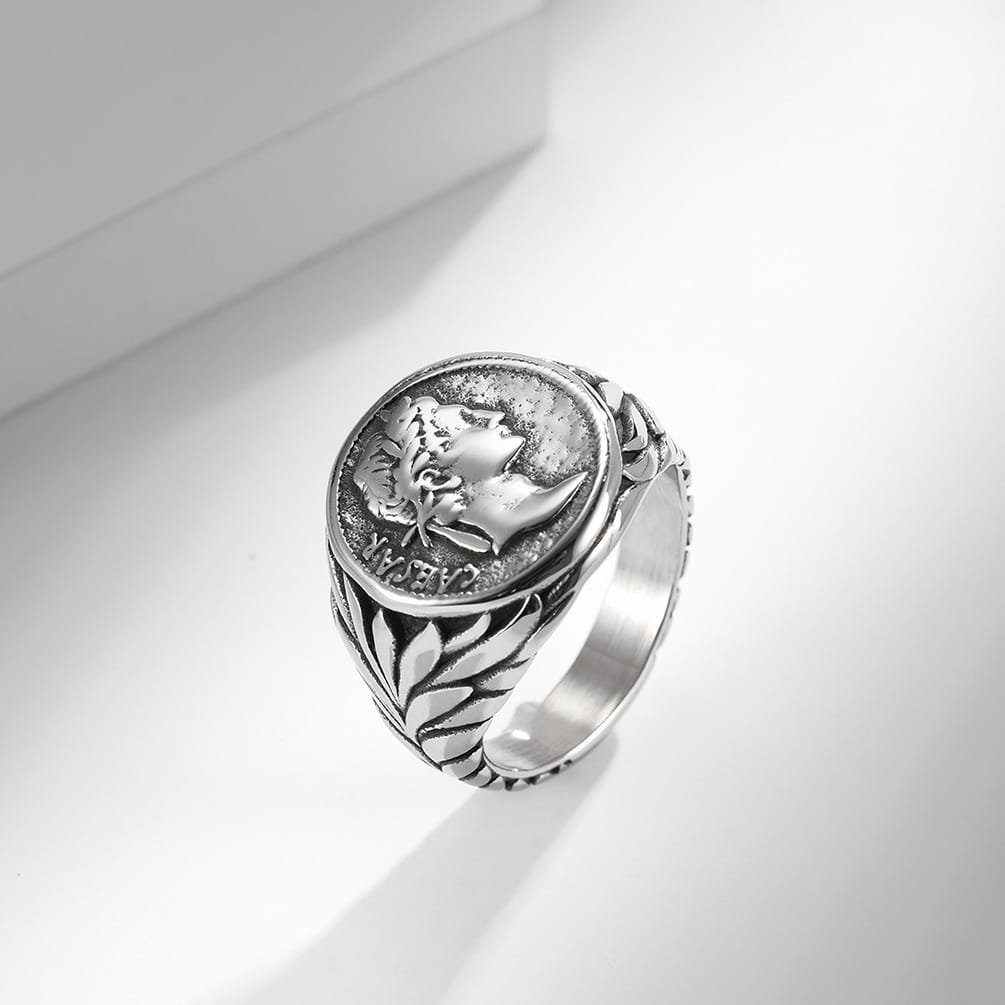 Silver-toned vintage caesar portrait stainless steel signet ring featuring an embossed classical figure profile with laurel leaves and detailed engraving on the band.