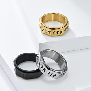 Vintage Caesar portrait stainless steel signet rings in gold black and silver with engraved runes on a white surface.