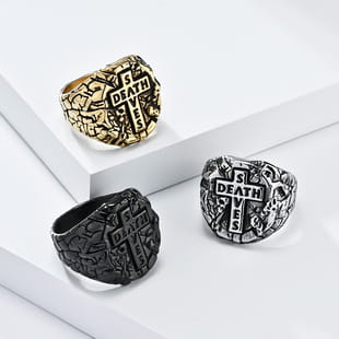 three vintage caesar portrait stainless steel signet rings featuring cross designs with intricate engravings and the word death inscribed on their faces