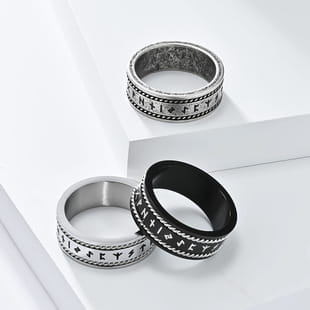 Silver and black rune-engraved vintage Caesar portrait stainless steel signet rings with textured patterned band design.