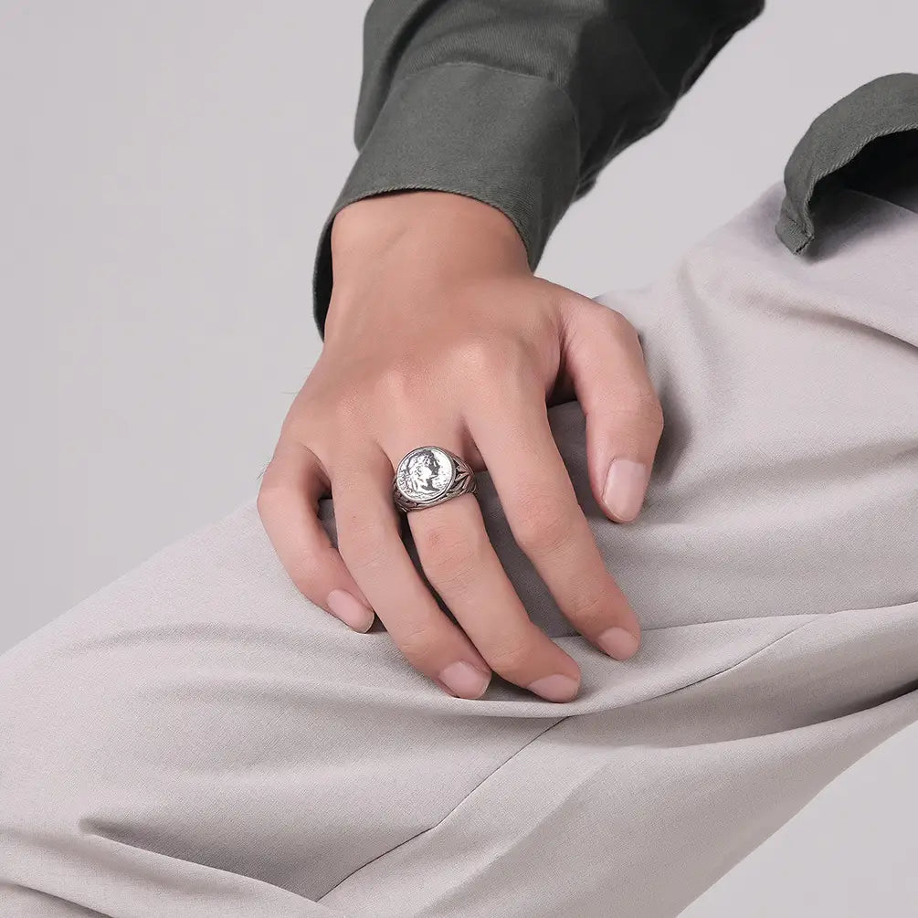 Silver-toned vintage Caesar portrait stainless steel signet ring featuring a detailed engraved portrait on its circular face with an ornate textured band.