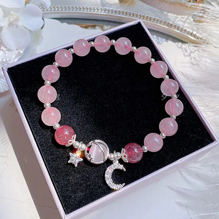 Handmade celestial moon and star crystal bead bracelet featuring pink rose quartz beads and silver-toned moon star and crescent charm accents.