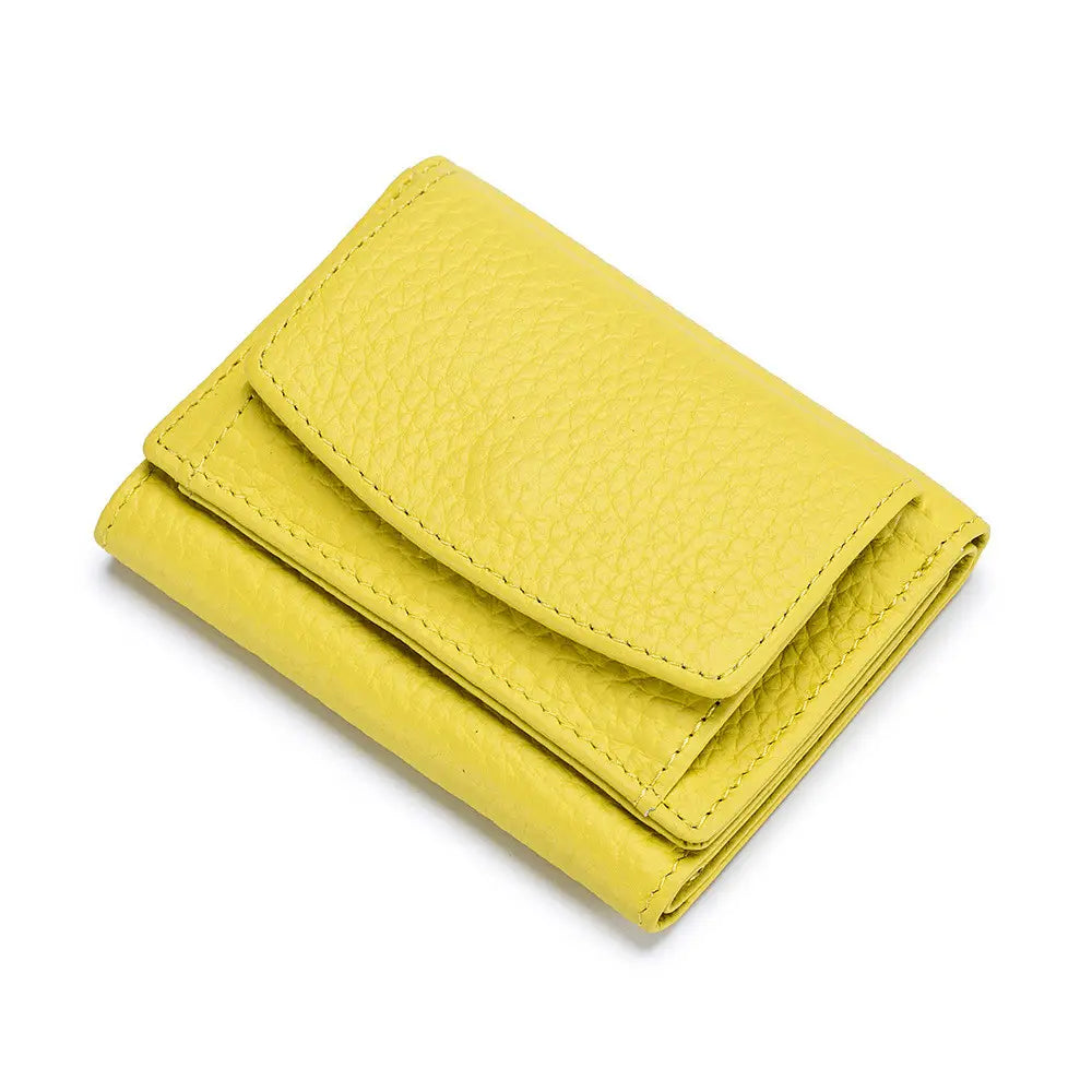 A compact vibrant yellow leather mini wallet made of textured cowhide with neat stitching designed as a bifold card holder.