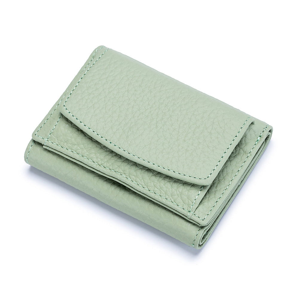 A compact light green leather mini wallet made of textured cowhide with matching stitching designed as a bifold card holder.
