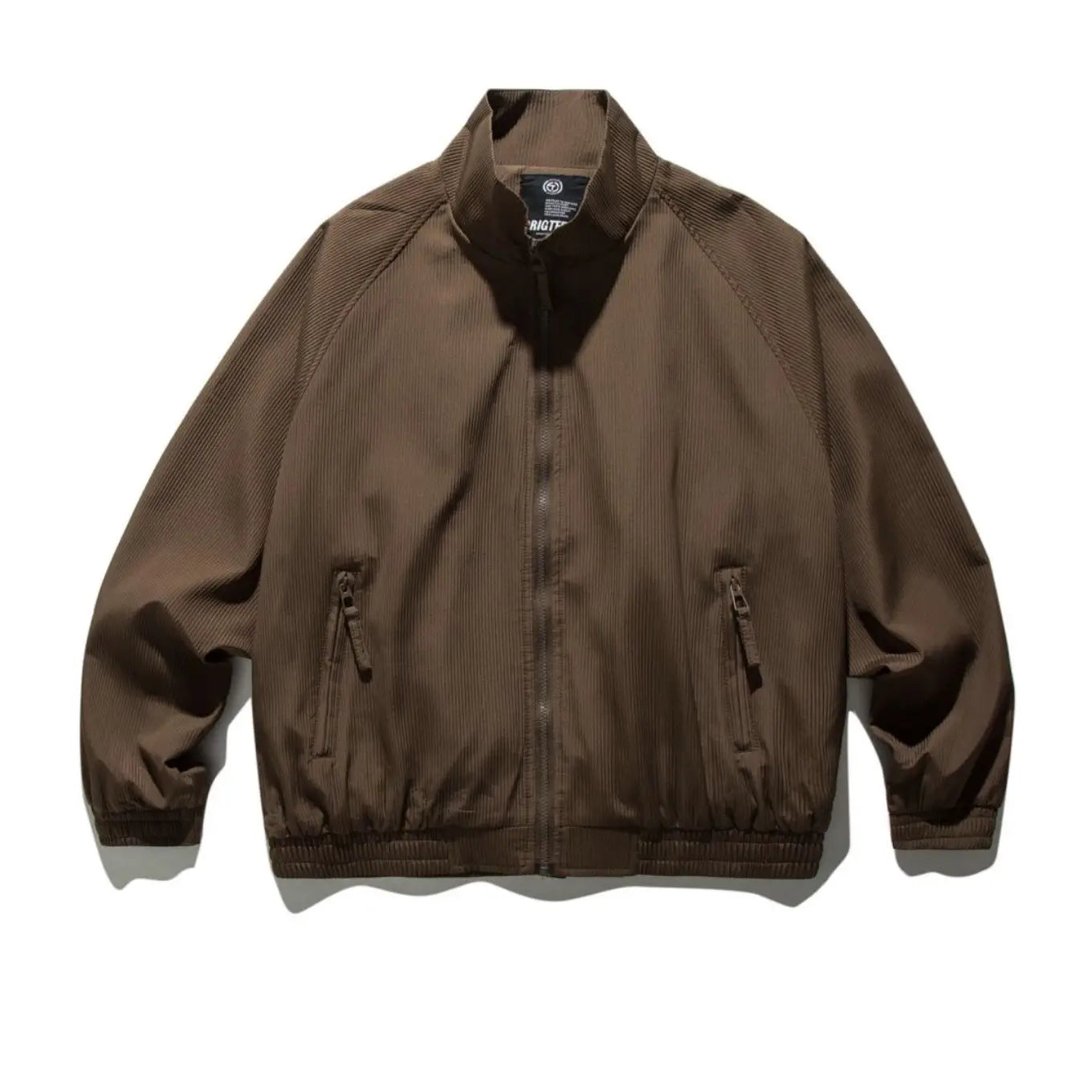 Brown corduroy bomber jacket with ribbed cuffs and waistband featuring a retro loose fit and zipper outerwear design.