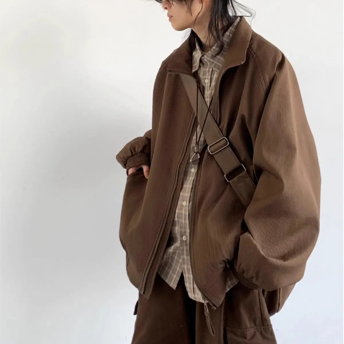 Brown corduroy bomber jacket with a relaxed fit and visible zipper closure suitable as retro loose outerwear.