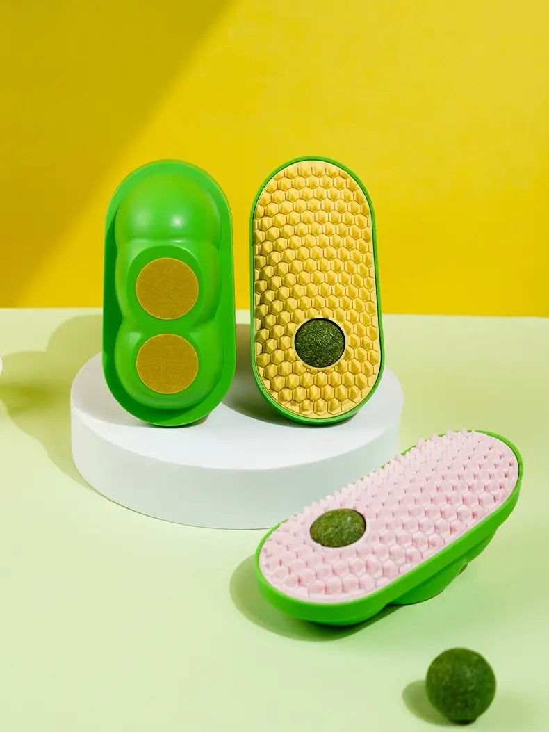 Grüne, avocadoförmige Katzenbürste zur Selbstpflege und Silikon-Kratzspielzeug mit strukturierter Wabenmuster-Oberfläche und zentraler kreisförmiger grüner Auflage.