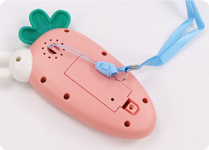 Pink carrot-shaped baby toy phone with green leafy top and white bunny ear detail designed as an educational music toy.
