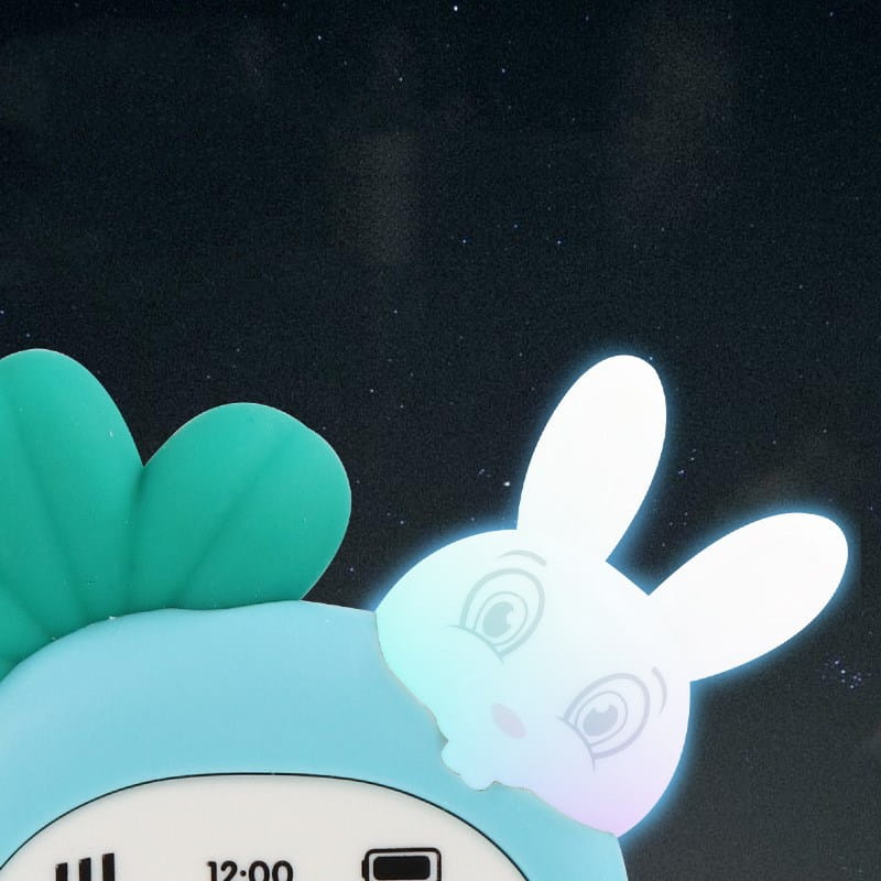 a glowing white rabbit baby toy phone in a carrot shape with long ears and a soft pastel gradient designed as an educational music toy set against a dark background