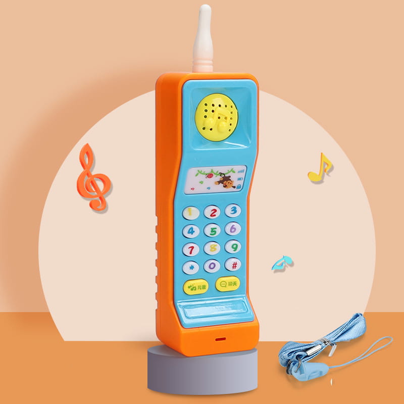 Bright orange and light blue plastic baby toy phone in carrot shape with a yellow speaker, colorful number buttons, antenna, and educational music features.