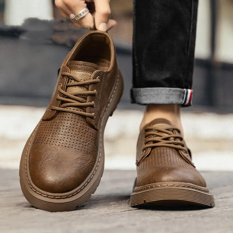 Men’s brown leather business casual shoes with lace-up closure, perforated detailing, and chunky sole.