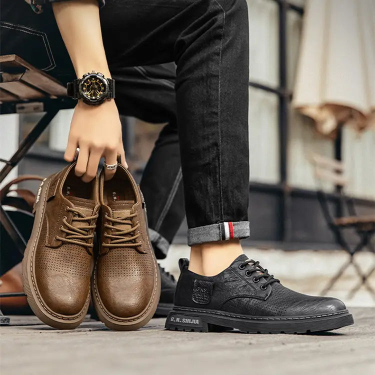 Men’s leather perforated business casual shoes in brown with lace-up design and chunky sole.